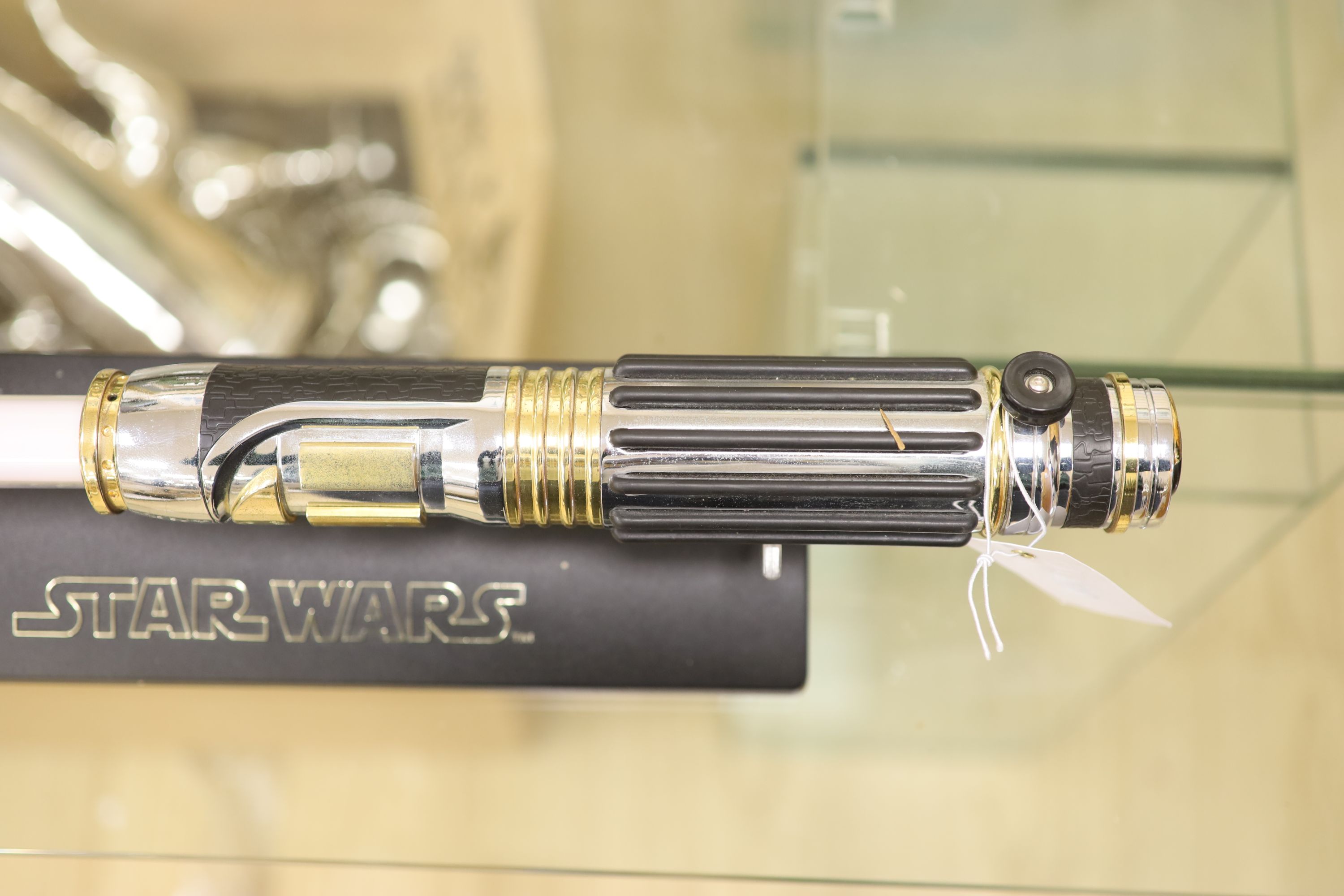 A 2005 Lucasfilm Ltd/Master replicas inc. Star Wars light saber on stand